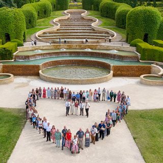 An aerial view of people forming a heart shape