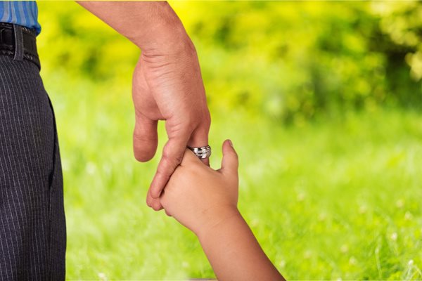 Child holding adult's hand