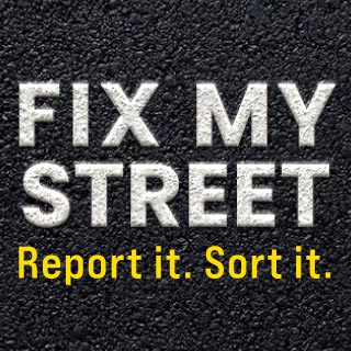 Photo of a road with text saying "Fix My Street. Report it. Sort it." Click here to report a problem.
