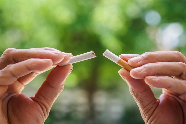 Cigarette being snapped in half