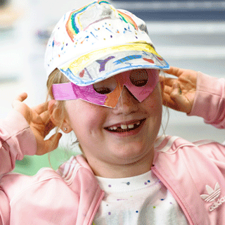 Young girl with blond hair taking part in an activity group