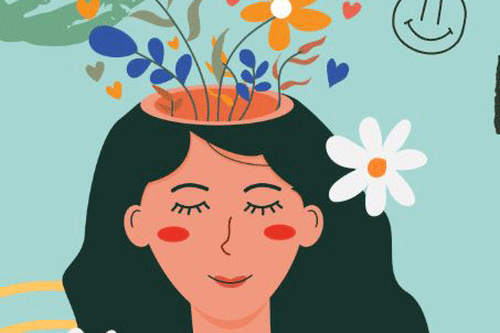 woman with eyes closed, smiling surrounded by flowers