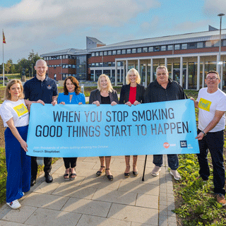 People holding a Stoptober banner