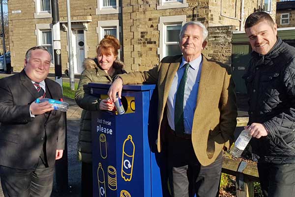 Councillors and council officers at a new recycling bin