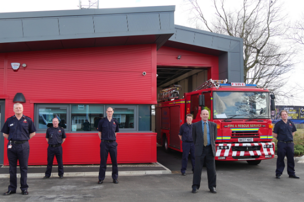 Red fire station and men wearing 