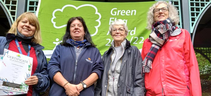 Image showing Four park workers showing off the certificate of achievement