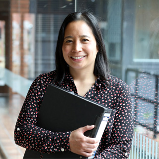 A business admin apprentice smiling in an office