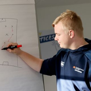 Apprentice drawing a diagram on a whiteboard