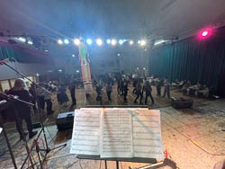 Photo from the stage showing the sheet music and the hall foor with students dancing