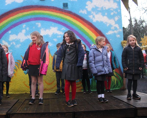 A group of school children trying to clog dancing on a stage