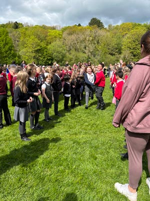 A group of kids playing around outside while preparing to perform