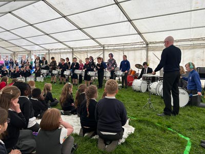 A band performing with drums