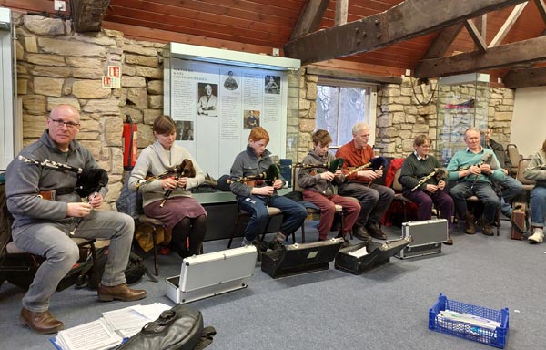 Another angle of the pipers playing the pipes