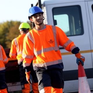 Highways apprentice holding cone